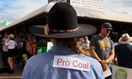 A pro-Adani coalmine supporter wears a 'Pro Coal' sign on her shirt