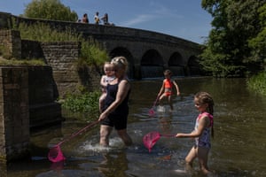 Margaret Quilligan, and her granddaughter Margaret Rose, two, and nieces Luxey, seven, and Noradoll, six, play under Five Arches Bridge in Sidcup, London