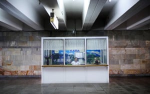 A cashier at an entrance to the metro