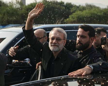 Larijani waves as he is showered with rice