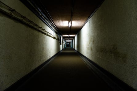 A long, stark, dimly-lit corridor