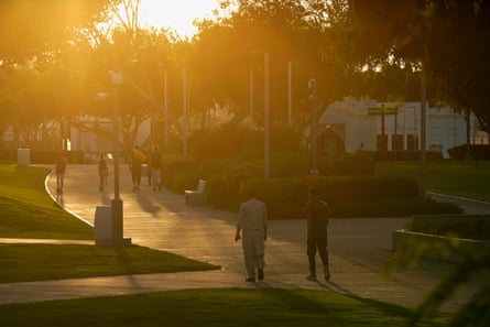 People walk in Al Bidda Park on a spring evening in Qatar.