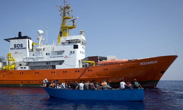 African migrants next to the Aquarius rescue ship during a search and rescue operation in the Mediterranean Sea, north of Libya