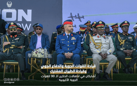 Arab and African military officers sitting on a podium