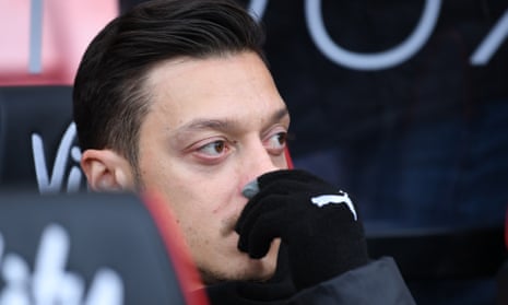 Mesut Ozil watches from the bench at the Vitality Stadium