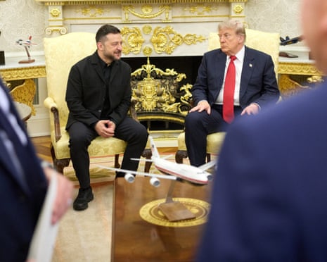 two men speak while seated