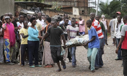 Men carry away a dead body in the Nyakabiga neighbourhood of Bujumbura, Burundi in December.