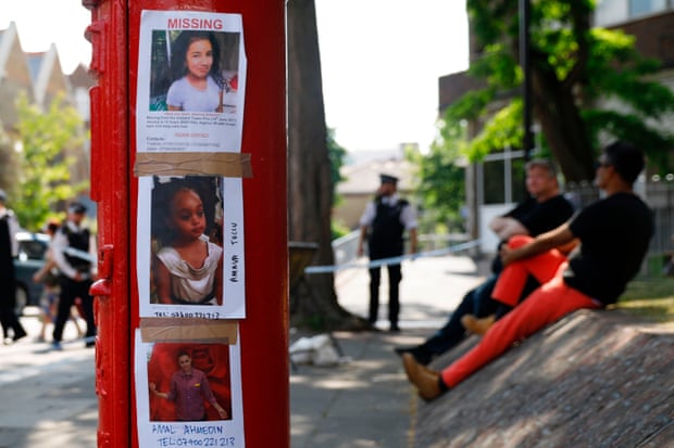 Photos of people missing after the Grenfell Tower fire taped to a post box near the scene in North Kensington, west London