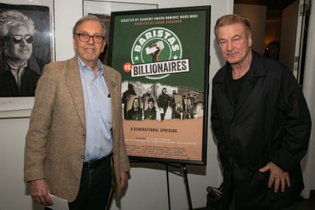 two men stand by a film poster
