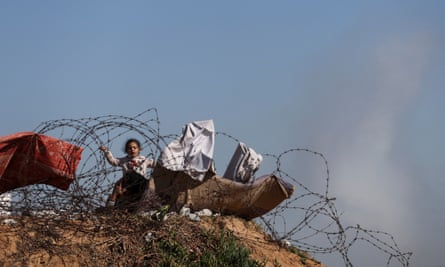 Israel says Gaza fighting could last a year, amplifying fears of regional war | Israel-Gaza war 1 A displaced Palestinian child plays in Rafah near the border with Egypt