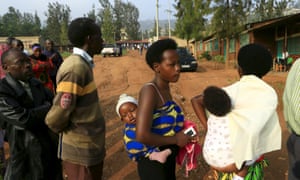 Mothers carrying their babies wait to vote in a referendum on amending the nation’s constitution to allow president Paul Kagame to seek a third term.