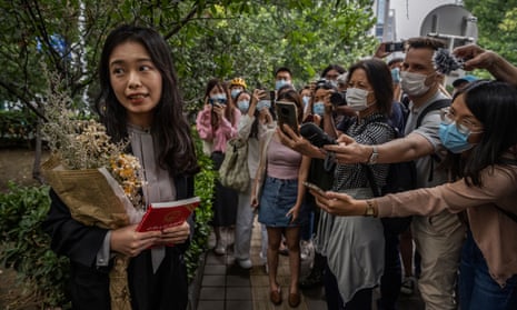 A leading figure in China's #MeToo movement Zhou Xiaoxuan, known also as Xianzi, left, speaks to journalists and supporters outside court before a hearing in her case in September.