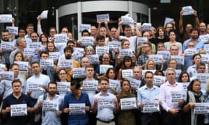 Journalists, photographers and staff from Nine hold signs in support of AAP outside Nine’s offices in Sydney on Tuesday