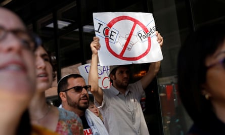 Activists protest outside the Palantir Technologies software company in 2019. A sign shows a drawing of Ice and Palantir holding hands
