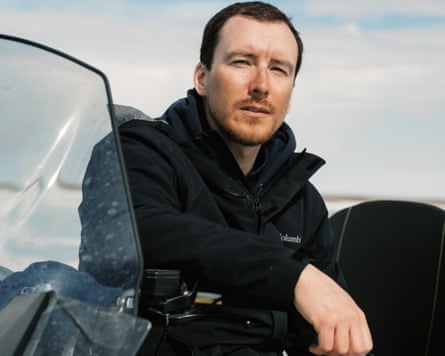 Kyle Weese sitting on his snowmobile