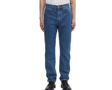 A cropped at waist image of a model wearing Asket The Regular blue jeans