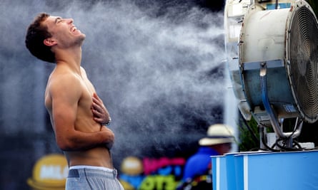 Poland’s Jerry Janowicz is sprayed with cool water at the Australian Open tennis championship in Melbourne, Australia in 2014.