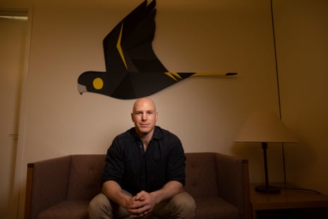 David Pocock beneath a mural of a bird