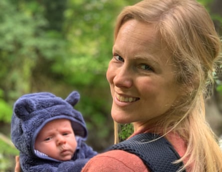 Emily Hoyle, who died of a drug-resistant infection aged 38, smiling and holding a baby.