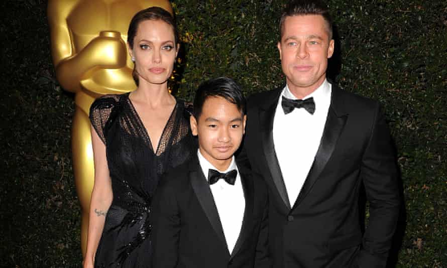 Standing together: Angelina Jolie and Brad Pitt with their eldest son Maddox. Now 14, he is co-producing the film First They Killed My Father.