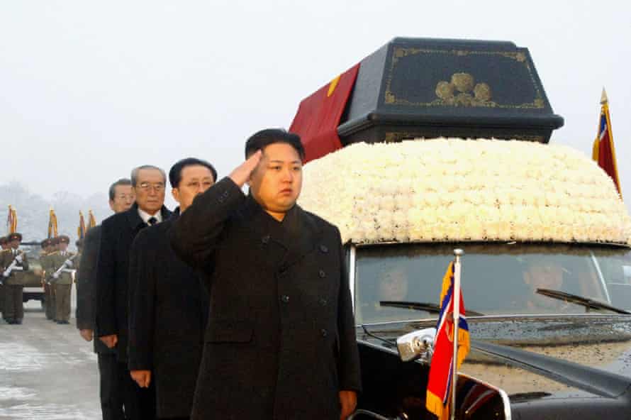 Kim salutes besides the convoy carrying the body of his father, the late leader Kim Jong-il at Kumsusan memorial palace in Pyongyang.