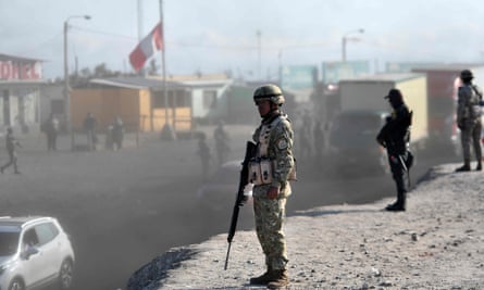 Soldiers stand guard on a highway in the Arequipa region, southern Peru