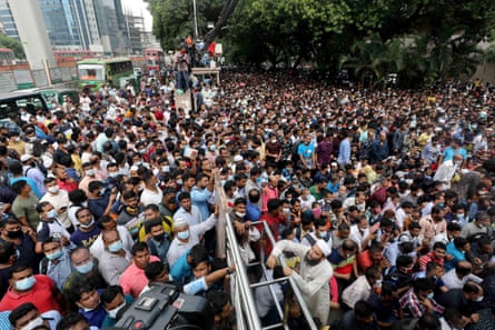 A large crowd of people gathers in front of Saudi Airlines’ office in Dhaka