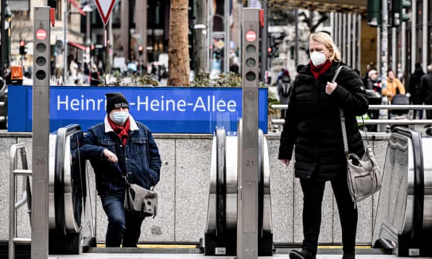 Pedestrians cross the Heinrich-Heine-Allee in the city center of Duesseldorf, Germany, on 20 January.