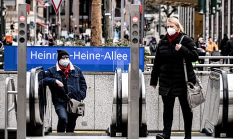Pedestrians cross the Heinrich-Heine-Allee in the city center of Duesseldorf, Germany, on 20 January.