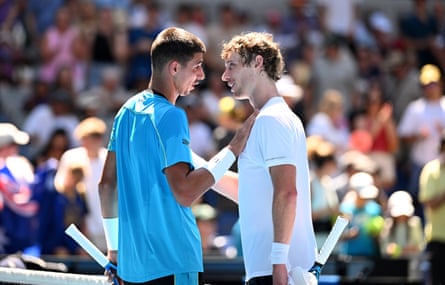 Alexei Popyrin and Marc Polmans each have a hand on the other’s chest as they speak after their match
