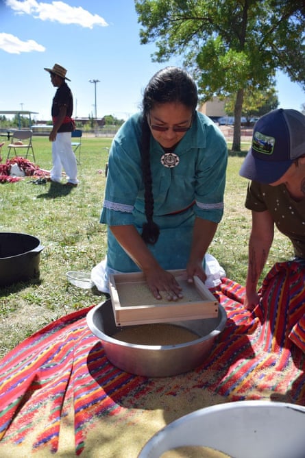 Beata Tsosie-Peña winnows amaranth, the process of separating the seeds from the chaff.