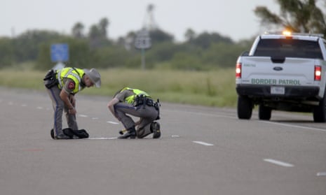 Texas department of public safety survey the area where 10 people were killed after a van carrying migrants tipped over south of the Brooks county in Encino, Texas, on 4 August.