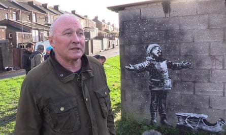Ian Lewis beside the Banksy artwork in Port Talbot
