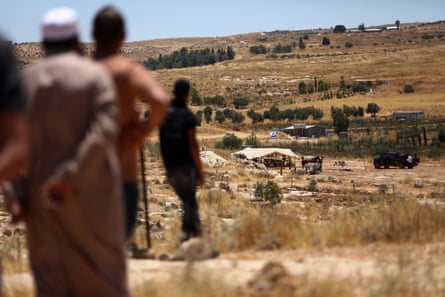 Palestinians watch settlement activities of Israelis in the Masafer Yatta area of Hebron, West Bank.
