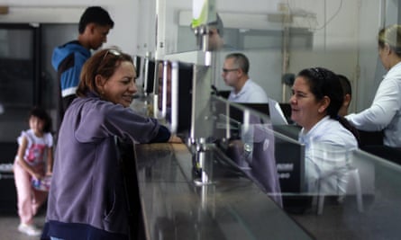 A Venezuelan woman stamps her passport to leave Colombia and enter Venezuela in Villa del Rosario, Colombia, last week.