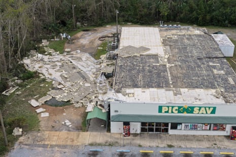 aerial view of store's roof debris strewn across grass