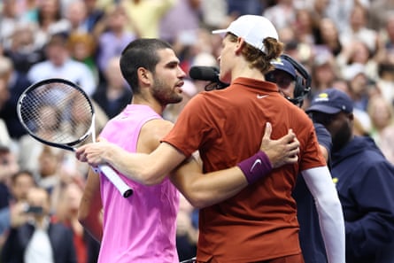 Carlos Alcaraz and Jannik Sinner greet each other at the net at the conclusion of their match.