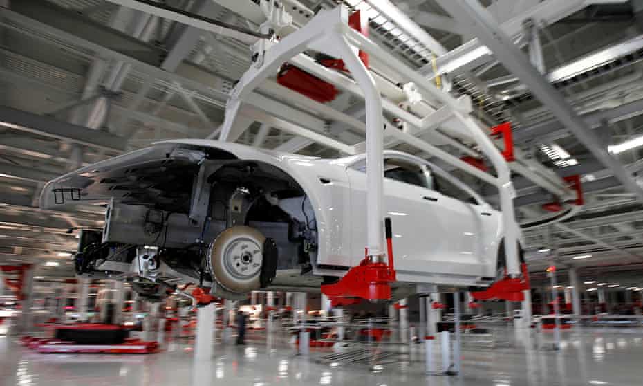 The body of a Tesla Model S is transported by an automated crane at the carmaker’s factory in Fremont, California.