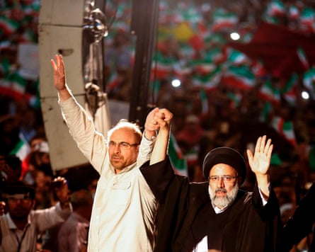 Mohammad Bagher Ghalibaf holds hands with Ebrahim Raisi in 2017.