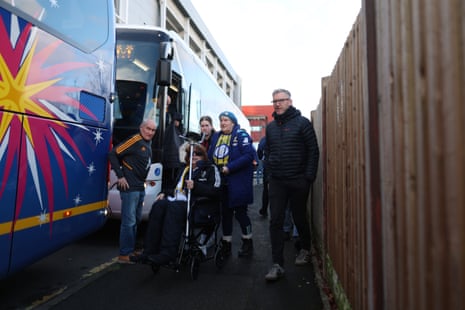 Leeds United fans alight from their bus outside Deepdale prior to thir team’s match against Preston.