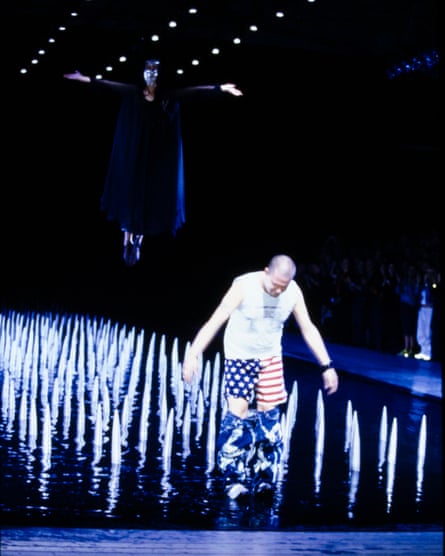Spikes and the star-spangled banner… Alexander McQueen takes a bow at the end of his spring-summer 2000 ready-to-wear show.