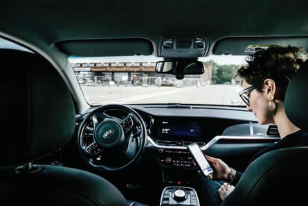 Silvia Avanzini (Head of Communications at Vay) checks the app used to start and end journeys, while the car is driven remotely.