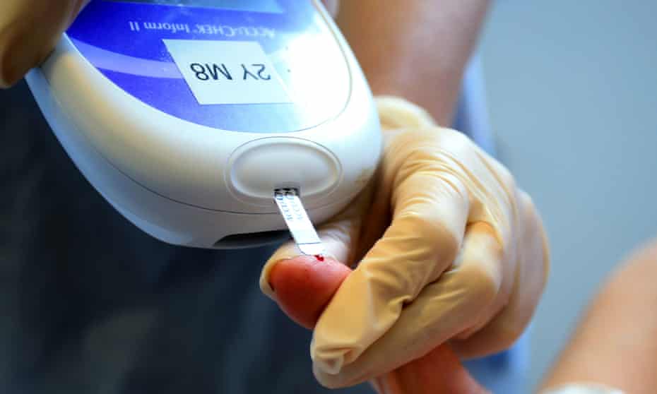 A nurse giving a patient a diabetes test