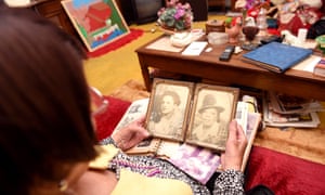 Canada looks at an old photo of herself.