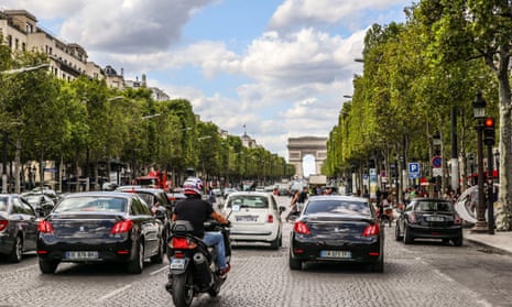 Gardener Safiullah struggling to water plants on the Champs-Élysées during the heatwave