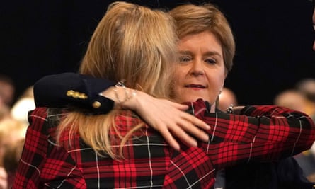 A woman with her back to the camera hugs Nicola Sturgeon