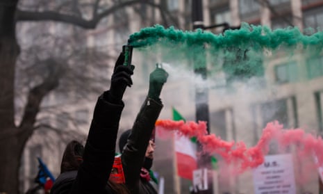 Demonstrators release smoke the colours of the Iranian flag in front of the EU offices in Washington