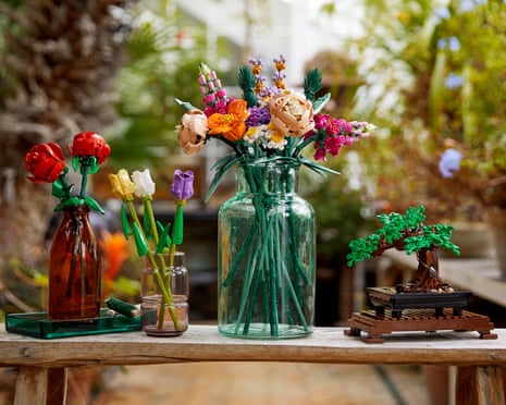 Four vases with brightly coloured flowers made from Lego