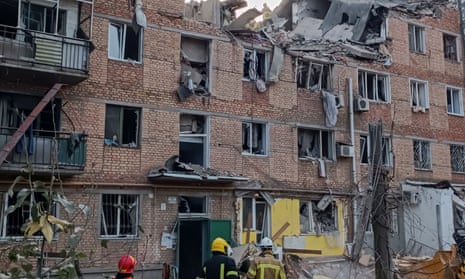 Rescuers work at a site of an apartment building damaged by a Russian military strike in Mykolaiv.