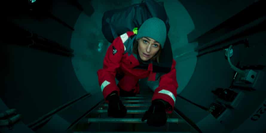 Suranne Jones climbing up a ladder in a submarine in Vigil.
